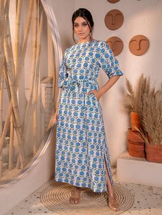 Elevate your casual wardrobe with this stunning white floral maxi dress doused with an eye-catching symmetrical pattern. Crafted from 100% cotton cambric in elegant white, it exudes timeless charm. The intricate floral butti hand block print adds depth and allure to the A-line silhouette, while the round neckline and straight mid-length sleeves offer a classic yet contemporary look. With two convenient pockets, it seamlessly blends style and functionality. Perfect for any casual occasion, this dress effortlessly captures attention and ensures you stand out with grace and sophistication. Step into this masterpiece and embrace effortless elegance wherever you go. Material: Cambric - 100% cotton Style/Print: Floral Butti Hand Block Print Number of Pockets: 2 Length: 55 inches Symmetrical Pattern, White Floral Maxi Dress, Mid Length Sleeves, Ruffle Sleeve Dress, Hand Block Print, Effortless Elegance, Maxi Dress Blue, White Maxi Dresses, Printed Maxi