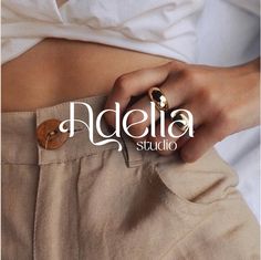 a woman's hand with a gold ring on her stomach and the words naddelia studio