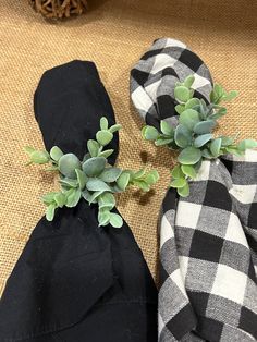 two black and white checkered cloths with green plants on them sitting next to each other