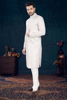 Make a statement with our Mens Sherwani- V2-S041! Perfect for grooms, this sherwani is adorned with elegant cutdana and pearls, adding a touch of sophistication to your wedding day look. Stand out from the crowd and feel like royalty on your special day. Don't miss out on this timeless piece! White Straight Kurta With Pearl Embroidery, White Sherwani With Naqshi Embroidery, Elegant White Nehru Jacket Straight Kurta, Groom's Transitional Sherwani With Chikankari Embroidery, Formal White Sherwani With Cutdana, White Sherwani With Cutdana For Formal Occasions, Traditional Drape Kurta With Pearl Embroidery For Reception, Pearl Embroidered Traditional Kurta For Reception, Festive Wedding Kurta With Pearl Embroidery