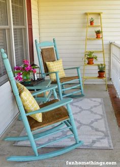 two rocking chairs on the front porch with yellow and blue pillows, potted plants