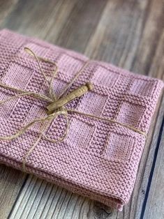 a pink knitted cloth wrapped in twine