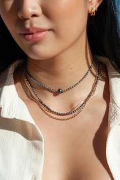 "Focusing on a single shimmering Tahitian pearl, this jewel toned peacock pearl necklace is a handmade Hawaiian treasure. It acts as a phenomenal portrayal of our tranquil mindful island living. ✦ DETAILS ✦ ✧ Name: Kaimalie (KAEE ma LEE eh) - Calm sea, quiet sea. ✧ Adjustable Length from: 14.5\"-16\". ✧ 1 8-10mm Genuine Tahitian Pearl AA-AAA Quality; tone and shape varies. ✧ 2-3mm Peacock Freshwater Pearls. ✧ 14kt Gold Filled Components, Extender, and Clasp. ✧ All Ke Aloha Jewelry pieces come pa Single Strand Tahitian Pearl Jewelry With Round Beads, Tahitian Pearl Chain Necklace With Round Beads, Tahitian Pearl Chain Necklace, Tahitian Pearl Drop Jewelry With Round Beads, Hawaii Necklace, Peacock Pearls, Calm Sea, Peacock Pearl, Gemstone Hoop Earrings