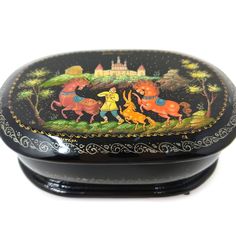 an ornately decorated black box with animals on it