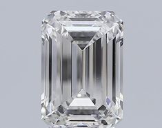 an emerald cut diamond on a gray background