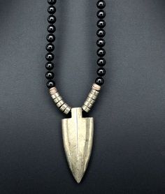 "This necklace was designed for the inner warrior with genuine Black Onyx and Pyrite 6mm beads. A large Pyrite arrow represents strength and power.  This really cool men's necklace is strung on the highest quality stainless steel beading wire for maximum strength and flexibility, then finished with a toggle clasp. Large Pyrite Arrows are approximately 2\" tall x 1 ⅞\" wide at the top. May your day be amazing, Saging Karma® 🦋 More Gemstone Necklaces https://www.etsy.com/shop/SagingKarma?ref=sell Black Hand-strung Amulet Necklace, Black Amulet Necklace, Handmade Black Arrowhead Necklace, Black Hand-strung Amulet Jewelry, Black Warrior Style Jewelry As Gift, Black Warrior Style Jewelry For Gift, Energy Positive, Karma Jewelry, Warrior Necklace