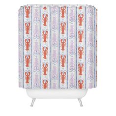 an orange and blue shower curtain with lobsters on striped fabric, in front of a white