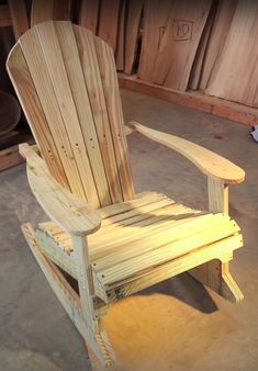 a wooden chair sitting on top of a cement floor