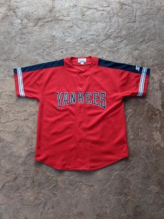 Vintage 90's New York Yankees Starter Jersey. Has fading, pilling and other wear. NO holes. In good vintage condition... Ready To Wear Size L. Measurements: Pit to Pit: 24 3/4" Collar to Bottom: 32" Pit to End of Sleeve: 6 3/4" Vintage Yankees Sweatshirt, Throwback Short Sleeve Tops For Sports, Throwback Short Sleeve Tops For Sports Events, Fan Apparel Baseball Jersey For Streetwear, Short Sleeve Baseball Jersey For Streetwear, Streetwear Fan Apparel Baseball Jersey Short Sleeve, Throwback Short Sleeve Baseball Jersey For Streetwear, Throwback Short Sleeve Top For College, Throwback Short Sleeve Top