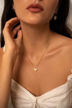 The Lise pearl heart necklace is handcrafted with a heart shaped freshwater pearl and a delicate heart chain. A perfectly classic romantic piece, easy to dress up or down.  14K gold-filled heart chain Heart-shaped freshwater pearl Hypoallergenic, suitable for even the most sensitive skin Each piece is delivered in a silk bag inside a gift box Sustainable packaging   Please note, as we use only natural pearls, shape and size may vary slightly.  We offer a one year guarantee from the date of deliv Elegant 14k Gold Filled Heart Necklace, Gold Dainty Heart Necklace With Pearl Charm, Gold Heart Necklace With Pearl Charm For Valentine's Day, 14k Gold-filled Heart Necklace With Heart Charm, Delicate Pearl Necklace With Heart Charm And Pendant, Pearl Heart Necklace With Clavicle Chain, Pearl Heart Pendant Necklace With Clavicle Chain, Heart Pendant Pearl Necklace With Clavicle Chain, Pearl Clavicle Chain Necklace With Heart Pendant