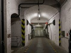 an empty tunnel with yellow and black caution tape