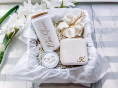 the contents of a personal care kit are laid out on a white tray with flowers