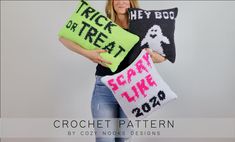 a woman holding two knitted pillows with the words trick or treat on them