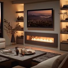 a living room with a couch, coffee table and fire place in front of a large window