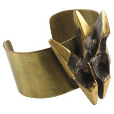 This impressive sculptural brutalist bronze cuff bracelet was designed by French sculptor and painter Henri Nogaret (1927 -). The large brass band is topped with a Mid-Century modernist abstract ornamental sculpture made of gilded bronze. The signature is engraved on the side. Please check our storefront, as we have the matching pendant necklace available. Measurements: circumference is 6.69 in (17 cm) - Opening is 1.25 in (3.2 cm) - Band width is 1.19 in (3 cm) - Sculpture element is 1.69 in wide (4.2 cm) x 2.32 in high (5.8 cm) - Fit a Medium size wrist with an average 6.50 in circumference (16.5 cm). Feel free to double-check the measurements and ask any questions you have before making your purchase. This item is a final sale. No returns will be accepted for an unfit size. Bronze Cuff Bracelet, Dagger Earrings, French Sculptor, Mommy Jewelry, Jewelry Staples, Silver Ring Designs, Antique Bracelets, Enamel Bangle, Bold Jewelry