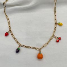 Get ready to add some deliciousness to your look with our Fruit Salad Charm Necklace! This fun accessory is adorned with vibrant enamel fruit charms that will give your outfit a burst of personality. Add some charm and quirkiness to your style with this playful necklace. 18kt gold plated enamel charms, featuring 5 charms (strawberry, blackberry, orange, cherry, and lemon) paperclip chain, links measure 12mmx4mm gold stainless steel for long-term worry-free wear with no tarnish Beaded Fruit Necklace, Fruit Necklace Beads, Fruits Necklace, Fruit Charm Necklace, Fruit Necklace, Enamel Charms, Star Girl, Accessories Earrings, Initial Charm