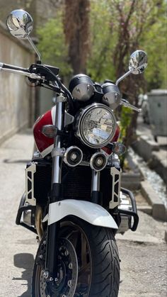 a red and white motorcycle parked on the street