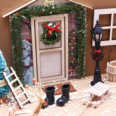 a doll house with christmas decorations and furniture