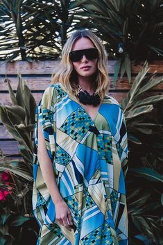 Limited run on this new and graphic take on the classic JG Caftan. This Pucci inspired print is thew perfect add on to a glam dinner or cover up by the pool. Our caftans are a voluminous one-size fits all garment, approximately 50" in length. The intention of this shape is to celebrate the magic of fabric and its captivating dance with form. JG one-size caftans are collected from petite to plus sized collectors, and everything in between. Machine wash cold, gentle cycle, and hang dry for optimal fabric preservation. Chic Printed V-neck Kaftan, Chic V-neck Printed Kaftan, Chic Multicolor Kaftan, Chic Oversized Kaftan For Vacation, Chic Blue Kaftan Beach Cover-up, Chic Blue Kaftan For Beach Cover-up, Printed V-neck Kaftan For Poolside, Beach Kaftan With Kimono Sleeves And Abstract Print, Chic Beach Poncho With Batwing Sleeves