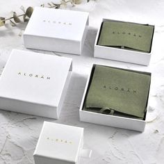 four white boxes with the names aloran on them sitting next to each other