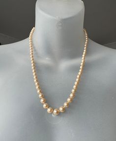 Immerse yourself in the world of timeless elegance with this exquisite long pearl necklace, refined with a high-quality sterling silver clasp. Each pearl in this necklace has been carefully knotted individually, which underlines its uniqueness and high quality standards. The necklace has a total length of around 53 cm and presents pearls in different sizes, which are elegantly arranged in a progression. The largest pearl is located centrally and measures approximately 0.8 cm in diameter, giving Elegant Single Strand Cream Pearl Necklace, Elegant Cream Single Strand Pearl Necklace, Classic Cream Pearl Chain Necklace, Classic Pearl Necklace With Sterling Silver Clasp For Wedding, Classic Cream Necklaces With Round Beads, Classic Wedding Pearl Necklace With Sterling Silver Clasp, Vintage Formal Necklaces With Sterling Silver Clasp, Formal Single Strand Cream Pearl Necklace, Formal Cream Single Strand Pearl Necklace