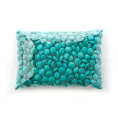 a bag filled with turquoise candy beans