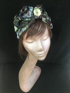 1940s floral print turban style head band. A real statement piece with a standard width inner Alice band attached within the lining to provide an easy to wear design. Completed with quills of fabric, buttons and lined with a fine fleece. The perfect accessory for style and added warmth. This unique creation is a stunning example of a vintage inspired accessory with an eye catching easy to wear and lightweight design. Bohemian Adjustable Headwrap With Matching Headband, Adjustable Bohemian Headwrap With Matching Headband, Bohemian Headwrap One Size Fits Most, Bohemian One Size Fits Most Headwrap, Adjustable Bohemian Headwrap Headband, Hippie Style Headwrap, Adjustable Bohemian Headwrap, Hippie Festival Headwrap One Size, Traditional Headscarf As Headband