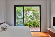 a bed sitting in a bedroom next to a sliding glass door