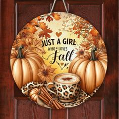 a painting of a cup of coffee and some cinnamons on a door frame with the words, just a girl who loves fall