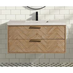 a bathroom vanity with two drawers and a sink in the middle, against a white tiled wall