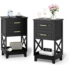 two black nightstands with flowers and vases on each side, one has a clock