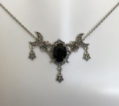 "This is a new handmade necklace. It is made with antiqued silver plated filigrees, accented with a high quality JET BLACK glass rhinestone. Decorated portion is 2 1/2\" wide and 1 3/4\" tall in the center. Necklace is adjustable 15-18\" with a lobster clasp and chain extender. If you would like a different length, please send us a message." Gothic Necklace Aesthetic, Romantic Goth Accessories, Gothic Silver Crescent Necklace, Gothic Crescent Silver Necklace, Adjustable Gothic Antique Silver Necklace, Adjustable Oxidized Gothic Necklace, Victorian Gothic Jewelry, Star Goddess