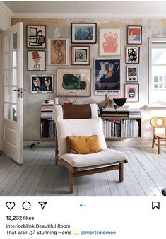 a living room with pictures on the wall and a chair in front of a door