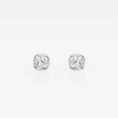 Get cozy with these cushion shaped diamonds wrapped around with a beautiful bezel. Lab grown diamond stud earrings that make a perfect gift for that perfect someone. Luxury Diamond Earrings With Cushion Cut And Accents, Elegant White Gold Diamond Earrings With Bezel Setting, Cushion Cut Brilliant Diamond Earrings, Elegant Cushion Cut Diamond Earrings With Brilliant Finish, Cushion Cut Diamond Luxury Earrings, Classic Cushion Cut Bezel Set Jewelry, Luxury Silver Cushion Cut Diamond Earrings, Classic Cushion Cut Jewelry With Bezel Setting, Fine Jewelry Diamond Earrings With Cushion Cut