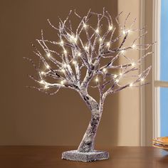 a lighted tree is sitting on a table