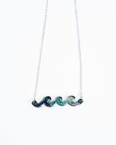 Dive into style with this stunning stone necklace set in durable stainless steel. The unique wave design features crushed stones in shades of blue and turquoise, each one with its own individual touch. Great for those who love to be by the sea. The wave necklace is made of natural gemstones and Jewelry grade Stainless Steel, high polished and shiny on both sides, oxidation resistant, never get tarnished or change color, hypoallergenic, nickel-free and lead-free, no irritation for sensitive skin. Adjustable Wavy Sterling Silver Jewelry, Handmade Silver Wavy Jewelry, Ocean-inspired Turquoise Sterling Silver Jewelry, Turquoise Ocean-inspired Sterling Silver Jewelry, Sterling Silver Wavy Necklace For Gifts, Turquoise Stainless Steel Jewelry As Gift, Turquoise Stainless Steel Jewelry As A Gift, Turquoise Stainless Steel Jewelry Gift, Blue Stainless Steel Necklace With Adjustable Chain