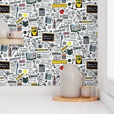 a white wall with black and yellow doodles on it