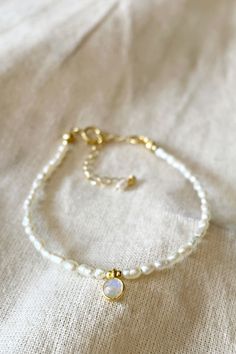 Pearl and moonstone are both the birthstone of June. Here together in this lovely dainty minimalist bracelet. #minimalistjewelry #pearlbracelet #pearljewelry #moonstonejewelry #moonstonebracelet #daintyjewelry #daintybracelet #bohowedding #weddingjewellery #weddingjewelryandaccessories #whiteandgold #pearlslover #freshwaterpearl #gemstonejewelry #gemstonebracelet Adjustable Bracelet With Pearl Pendant, Adjustable Pearl Bracelet With Pearl Pendant, Adjustable Pearl Bracelets With Pearl Pendant, Dainty Pearl Bracelet With Natural Stones As Gift, Spiritual Pearl Bracelet With Pearl Charm, Dainty Pearl Bracelet With Natural Stones, Dainty Beaded Round Pearl Bracelet, Elegant Moonstone Beaded Bracelets, Spiritual Pearl Bracelet With Charm