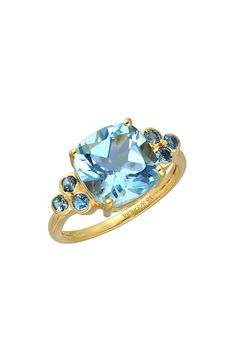 A brilliant-cut London blue topaz stone centers an 18-karat gold-plated ring with gleaming prongs that offer brilliant shine. 18k gold plate/blue topaz Imported Elegant Gold Birthstone Ring With Blue Topaz, Formal Gold Birthstone Ring With Blue Topaz, Gold Topaz Ring With Gemstone Accents, Gold Cushion Cut Topaz Ring, Elegant Gold Ring With Blue Topaz, Gold Cushion Cut Topaz Ring For Anniversary, Yellow Gold Blue Topaz Ring With Center Stone, Gold Blue Topaz Birthstone Ring With Prong Setting, Gold Birthstone Ring With Blue Topaz And Accent Stones