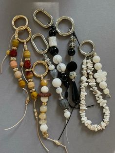 several different types of bracelets are laying on the table together, including beads and rings