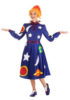 a woman dressed in a blue dress with stars and planets on it, holding her arms out