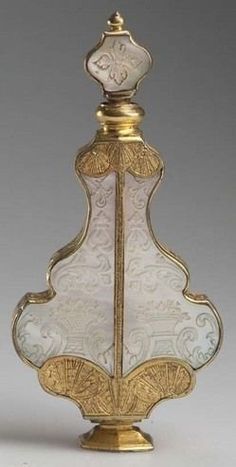 an ornately decorated glass bottle with gold trim