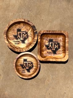 three wooden coasters with the word texas on them