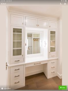 a large white cabinet with glass doors and drawers