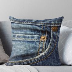 an old pair of blue jeans with gold buttons on the pocket throw pillow by designart