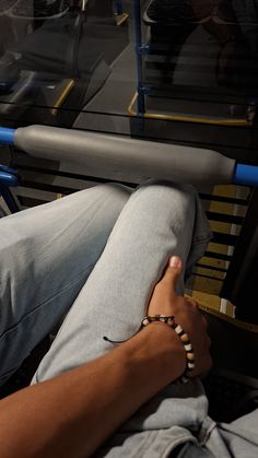 a person sitting on a bus with their legs crossed