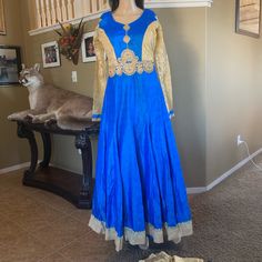 Not : Can Also Be Used As Single Piece Down Dress .It's 3 Pieces ( Anarkali , Salwar & Dupatta ) Dress Length 56" Inc Long Beautiful Work Done On The Front Thread And Stones . Fabric : Top Khadi Cotton And Inner Is Santoon And Also Net Net Inner To. Brest Size 36"Inc But It Can Be 40" There 2inc Fabric On Each Side. The Sleeves Are Attached To Top And There 24" Long Lace Work Done On It . Pants Are 47inc Long And It's Santoon Skin Color . Dupatta Fabric : Soft Net Border On Two Ends. Blue Floor-length Gown For Eid, Bollywood Style Fitted Choli For Eid, Fitted Floor-length Anarkali Set, Blue Floor-length Dupatta With Dabka, Fitted Long Sleeve Dress With Cutdana, Semi-stitched Royal Blue Bollywood Anarkali Set, Fitted Bollywood Choli For Eid, Festive Blue Lehenga With Long Sleeves, Gold Fitted Anarkali Churidar