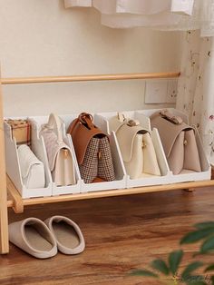 six purses are lined up on a shelf next to a pair of slippers