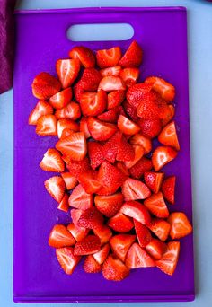 a cutting board with sliced strawberries on it