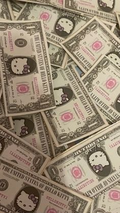 a pile of hello kitty money sitting on top of each other